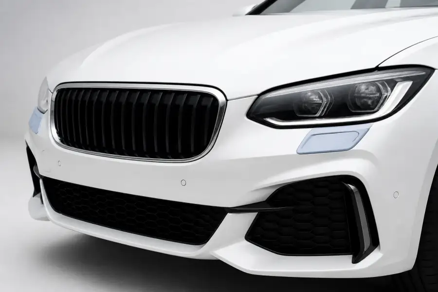Front Bumper Caps paint protection film coverage shown in smoke blue on a white vehicle